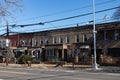 Row of Old Brick Neighborhood Homes along an Empty Street and Sidewalk in Astoria Queens New York Royalty Free Stock Photo