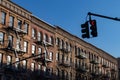 Row of Old Brick Residential Buildings with Fire Escapes on the Upper West Side of New York City and a Red Street Light Royalty Free Stock Photo