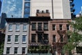 Row of Old Buildings along a Midtown Manhattan Street in front of Modern Skyscrapers in New York City Royalty Free Stock Photo