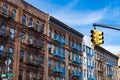 Row of Old Buildings with Blue Fire Escapes in Harlem of New York City and a Yellow Street Light Royalty Free Stock Photo