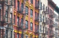 Row of old buildings with iron fire escapes, color toning applied, New York City, USA Royalty Free Stock Photo
