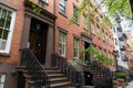 Row of Old Colorful Brick Residential Buildings along a Sidewalk in Chelsea of New York City Royalty Free Stock Photo