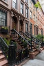 Row of Old Colorful Brick Residential Buildings along a Sidewalk in Chelsea of New York City Royalty Free Stock Photo