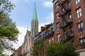 Row of Old Colorful Brick Residential Buildings with a Church along a Street in Chelsea of New York City Royalty Free Stock Photo
