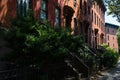 Row of Old Brownstone Homes in Clinton Hill in Brooklyn of New York City along an Empty Shaded Sidewalk