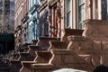 A Row of Old Colorful Brownstone Townhouses with Staircases on the Upper West Side of New York City