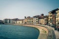 Row of old colorful buildings houses on embankment promenade of Arno river in historical centre of Pisa Royalty Free Stock Photo