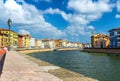 Row of old colorful buildings houses on embankment promenade of Arno river, Ponte Di Mezzo bridge in historical centre of Pisa Royalty Free Stock Photo
