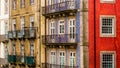 Row of old, colorful buildings with ornate balconies and tiles line a street in Porto, Portugal Royalty Free Stock Photo