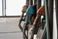 Row of an old dirty gas pump nozzle in a gasoline station Royalty Free Stock Photo