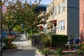 A Row of Old Fenced In Homes along a Sidewalk in Astoria Queens New York