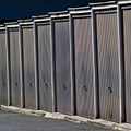 Row of old garages with metal doors near to residential district area. Royalty Free Stock Photo