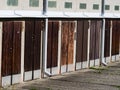 Row of old garages with wooden doors near to residential district area. Royalty Free Stock Photo