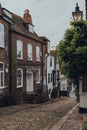 Row of old stone and wooden terraced house on empty Mermaid Street in Rye, UK