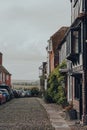 Row of old terraced house on a cobbled street in Rye ,UK, cars parked opposite Royalty Free Stock Photo