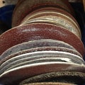 Row of old used sanding discs in a tradesman`s workshop