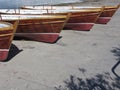 Row of old vintage wooden boats stand on dry dock for maintenance . Tuscany, Italy Royalty Free Stock Photo
