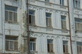 A row of old windows on a gray brick wall of the house Royalty Free Stock Photo