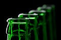 Row of open green beer bottles
