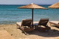 Row of outdoor chairs with colorful sun umbrellas, providing a shaded area for relaxation