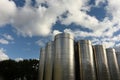 A row of outside stainless steel fermentation wine tanks Royalty Free Stock Photo