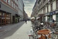 Row of parked bicycles and beautiful buildings on streets of Copenhagen, Denmark