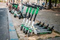Row of parked electric E scooters , escooter or e-scooter of the company LIME on sidewalk in Berlin