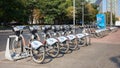 A row of parked rental bikes on the sidewalk on Mytnaya Street: Moscow, Russia - August 26, 2022