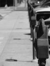 A row of parking meters on a city sidewalk Royalty Free Stock Photo