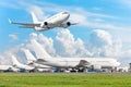 Row of passenger aircraft, airplane parked on service before departure. at the airport, other plane push back tow. One take off fr Royalty Free Stock Photo