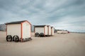 Row of pastel colored beach huts on a cloudy day Royalty Free Stock Photo