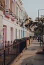 Row of pastel coloured terraced houses in Camden, London, UK