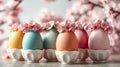 A row of pastel Easter eggs decorated with cherry blossoms, placed in egg cups Royalty Free Stock Photo