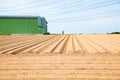 row pattern in a plowed field prepared for planting crops in spring