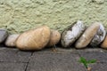 Row of pebble stones on the brick ground against a wall Royalty Free Stock Photo