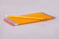 A row of pencils enter top left at an angle with erasers flush Royalty Free Stock Photo
