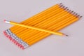 A row of pencils enter top left at an angle with erasers flush Royalty Free Stock Photo