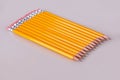 A row of pencils enter top left at an angle with erasers flush Royalty Free Stock Photo