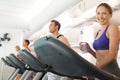 Row of people working out on treadmills