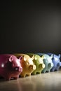 A row of piggy banks of different sizes and colors AI generated