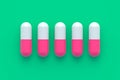 Row of pills on green background. Concept of healthcare and medical Royalty Free Stock Photo