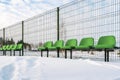 The row of plastic green seats at sports stadium