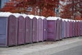 A row of portable rent toilets Royalty Free Stock Photo