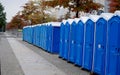 A row of portable rent toilets Royalty Free Stock Photo