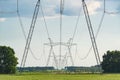 Row of power line support pylons Royalty Free Stock Photo