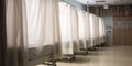 A row of pristine hospital beds and privacy curtains, contrasted against a calming background, concept of Medical