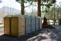 Row of public Portapotty toilets in a park