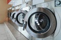 A row of qualified coin-operated washing machines in a public store. Royalty Free Stock Photo