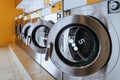 A row of qualified coin-operated washing machines in a public store. Royalty Free Stock Photo