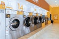 A row of qualified coin-operated washing machines in a public store. Royalty Free Stock Photo